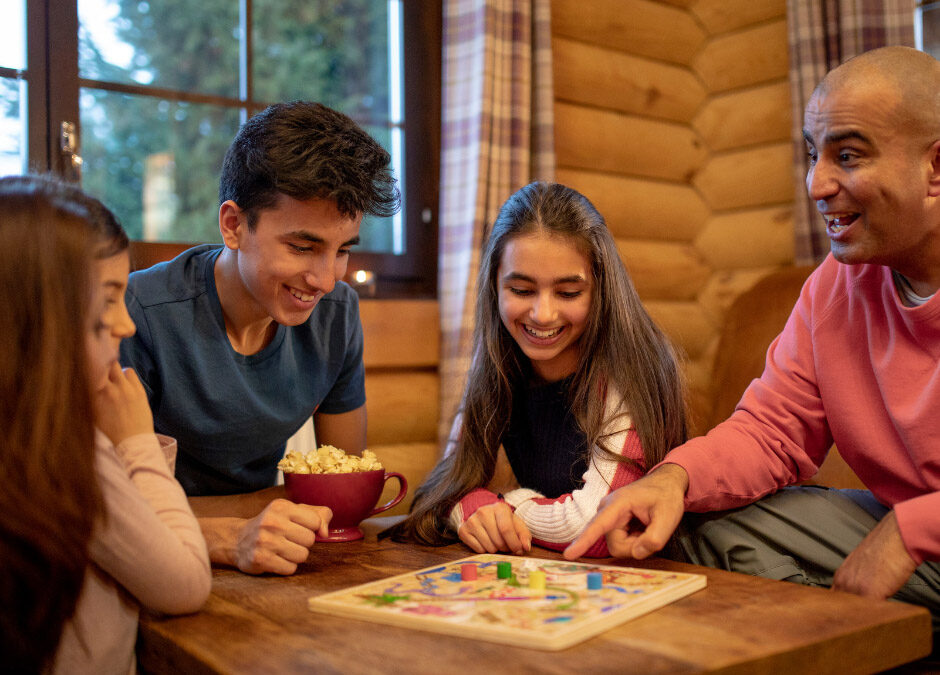 A family enjoying a board game together in a cozy room.